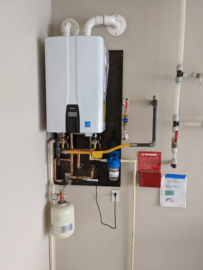 Professional plumber installing copper piping in a Nibley home